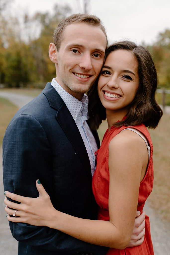 close up portrait of man and woman in red dress