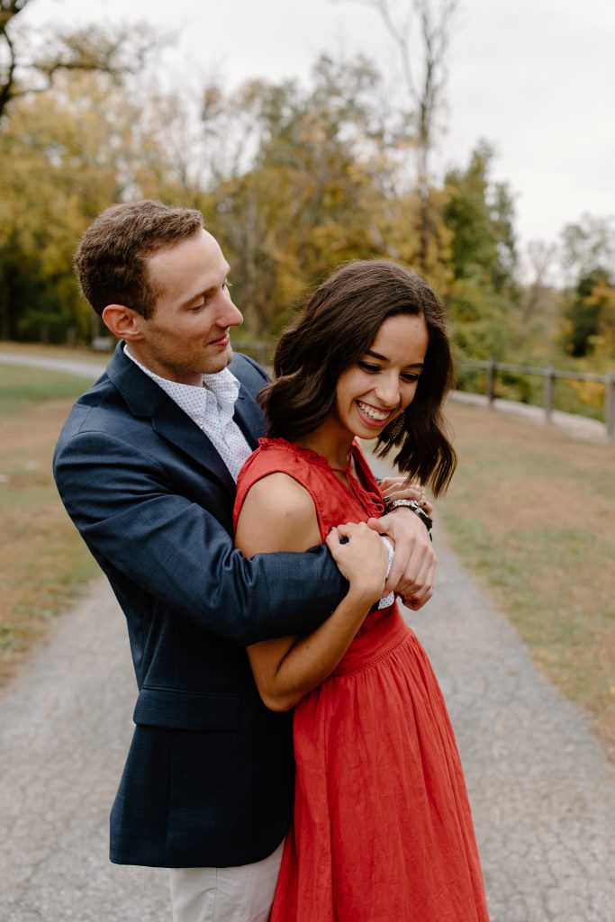 close up portrait of man and woman in red dress laughing