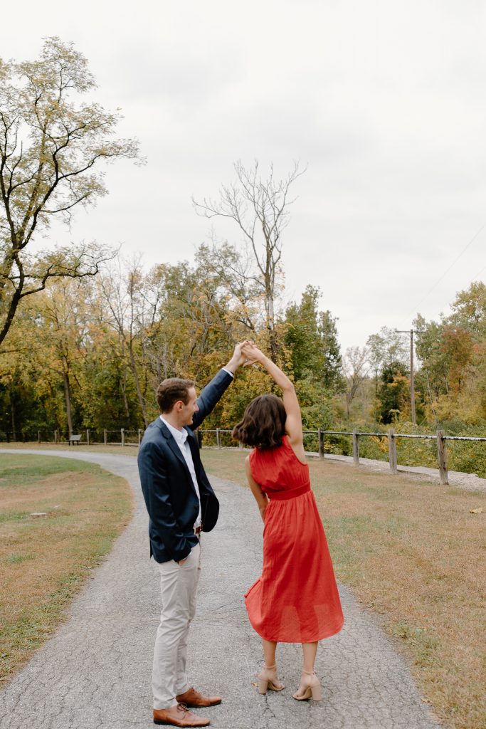 portrait of man and woman in red dress twirling