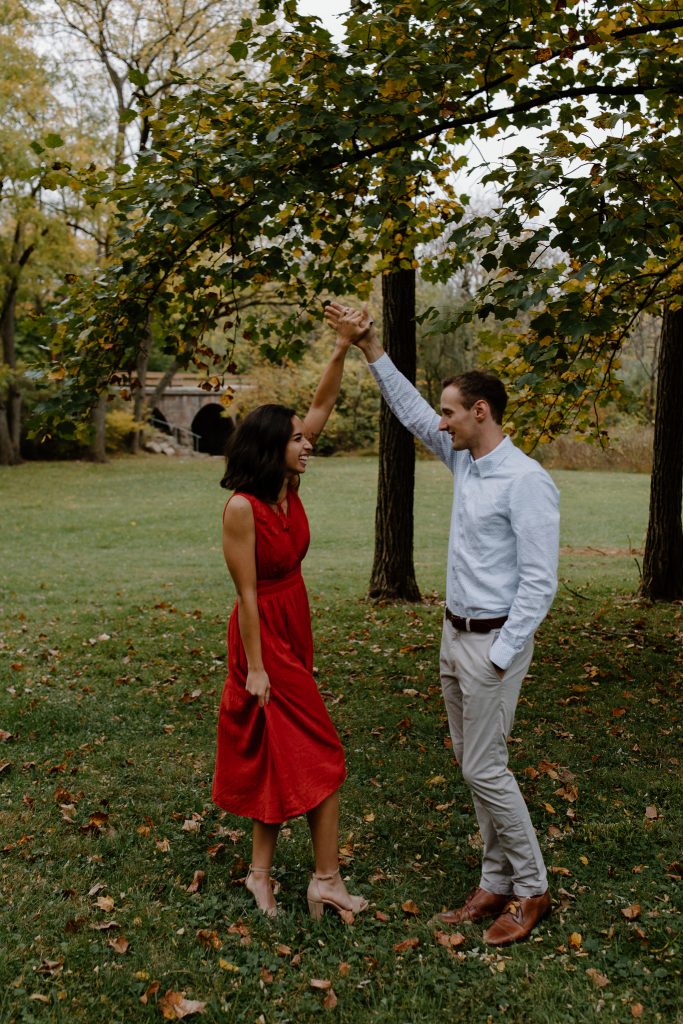 man and woman in red dress spinning