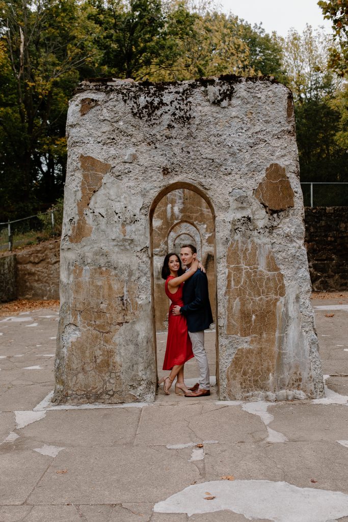 man and woman standing in arch smiling